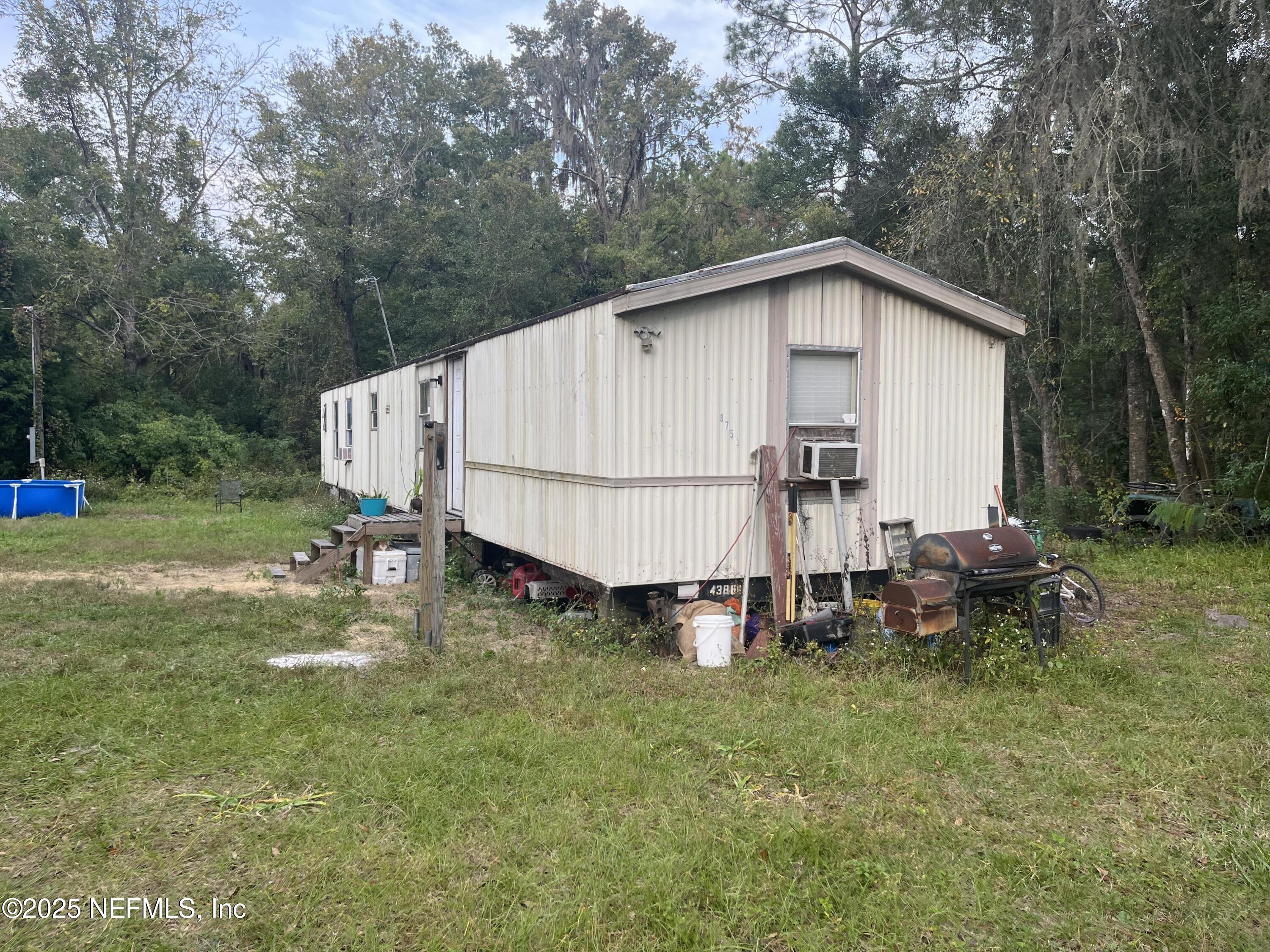 10017 Factory Avenue Hampton, FL 32044 - Photo 2 of 11 a backyard of a house with table and chairs