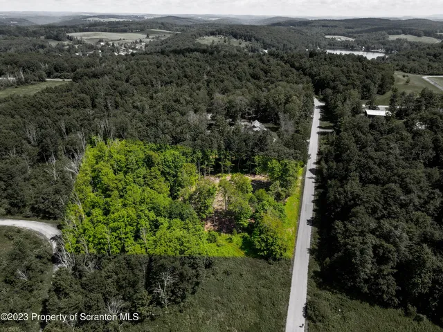 an aerial view of residential house with outdoor space