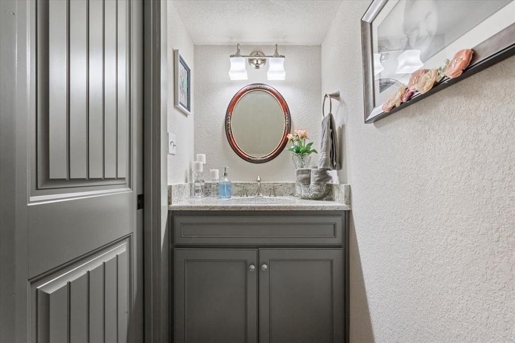 649 Wedgewood Drive China Spring, TX 76633 - Photo 25 of 39 Half bath with a textured wall, vanity, and a textured ceiling