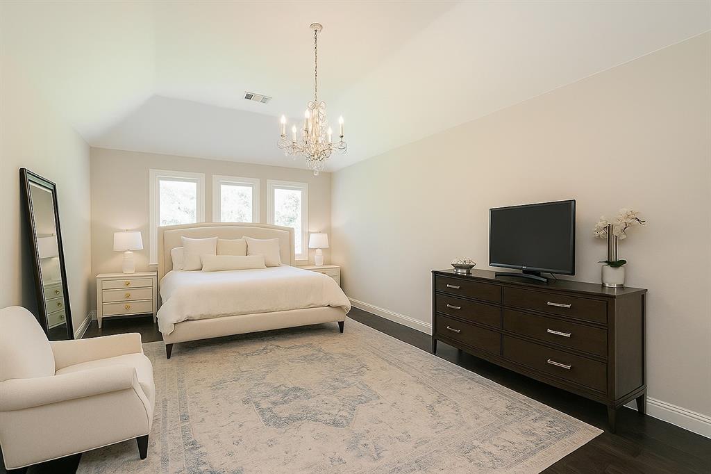 1908 Grey Bark Street Fort Worth, TX 76008 - Photo 13 of 31 Bedroom featuring a chandelier and dark wood-type flooring