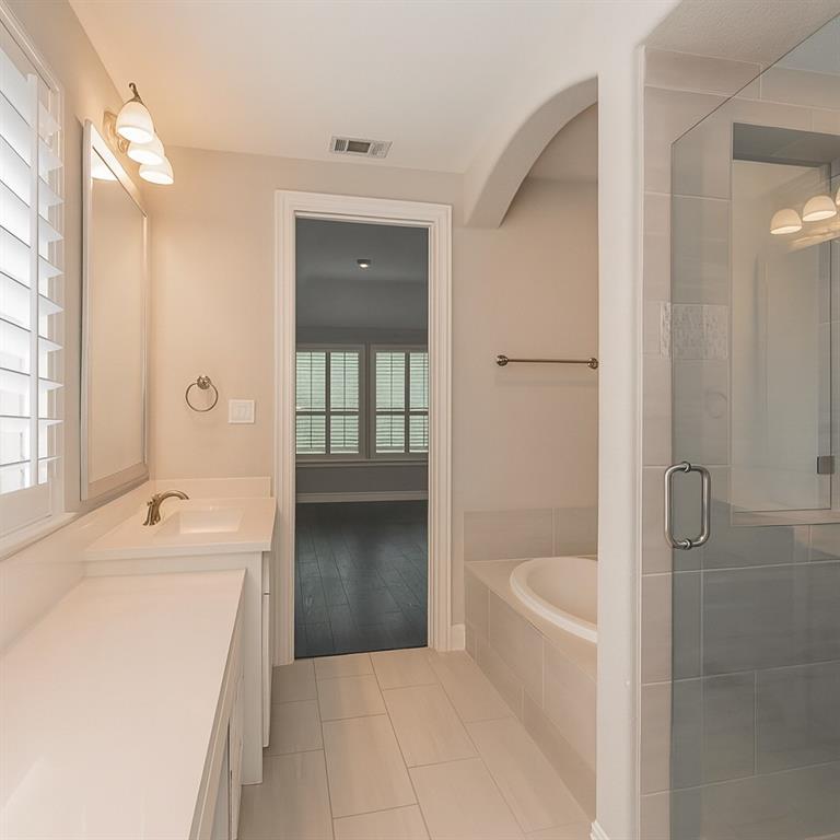 1908 Grey Bark Street Fort Worth, TX 76008 - Photo 14 of 31 Full bath featuring a bath, vanity, a stall shower, and light tile patterned flooring