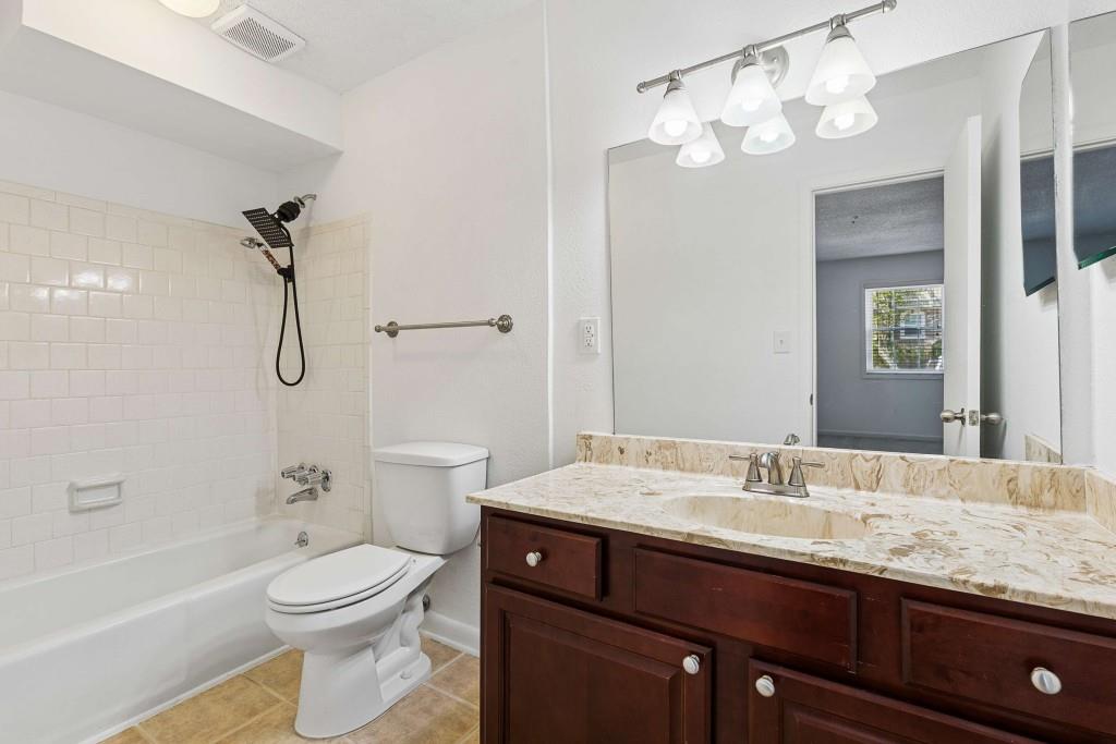 6900 Roswell Road, Unit Q6 Atlanta, GA 30328 - Photo 29 of 38 a bathroom with a granite countertop sink a toilet and shower