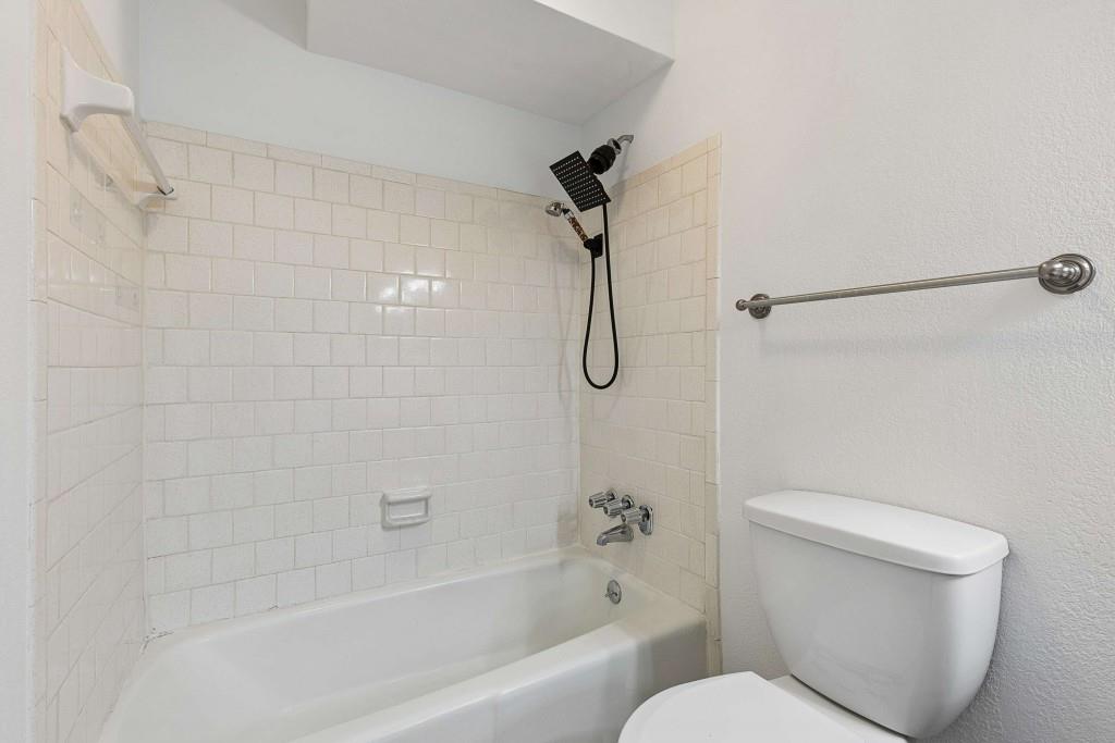 6900 Roswell Road, Unit Q6 Atlanta, GA 30328 - Photo 30 of 38 a white toilet sitting next to a bath tub and shower