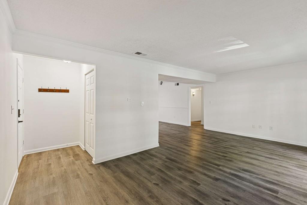 6900 Roswell Road, Unit Q6 Atlanta, GA 30328 - Photo 7 of 38 a view of an empty room with wooden floor
