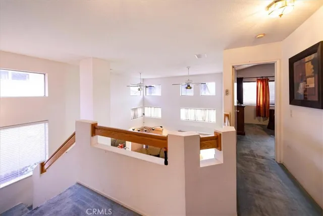 a dining hall with stainless steel appliances kitchen island granite countertop a refrigerator and a sink