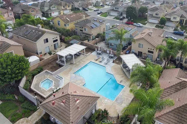 an aerial view of residential houses with outdoor space