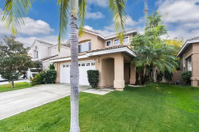 a view of a house with a yard and plants