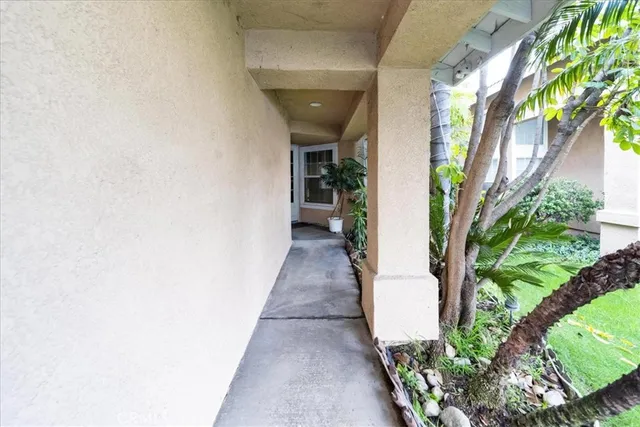 a hallway with beautiful frames and flower plants