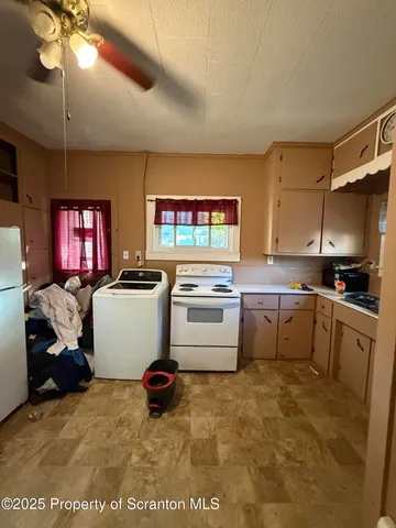a kitchen with a stove a sink and a refrigerator