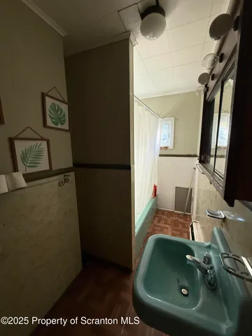 a bathroom with a sink and mirror
