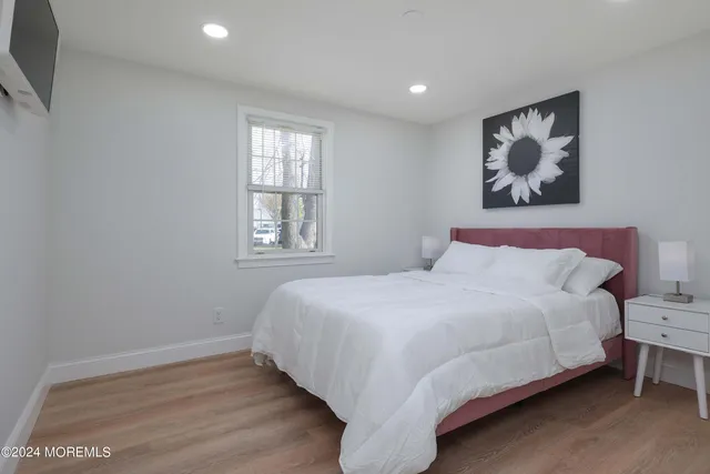 a bedroom with a large bed and a window