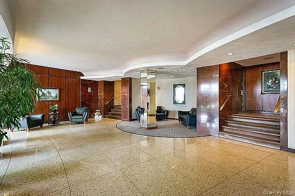 a lobby with furniture and floor to ceiling window