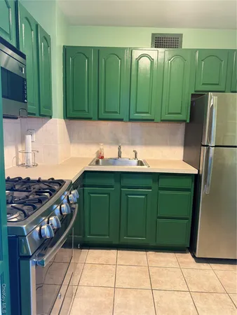 a kitchen with a refrigerator and a sink