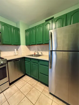 a kitchen with cabinets and a refrigerator