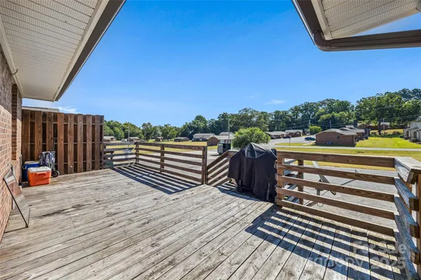 a backyard of a house with wooden floor outdoor seating and kitchen view