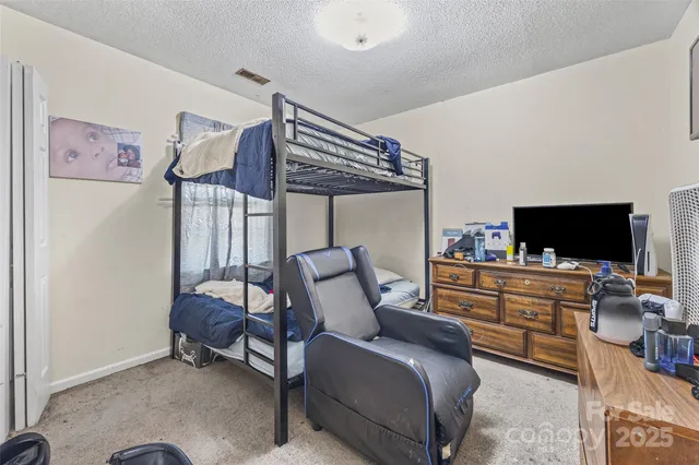 a bed room with a bed and a dresser