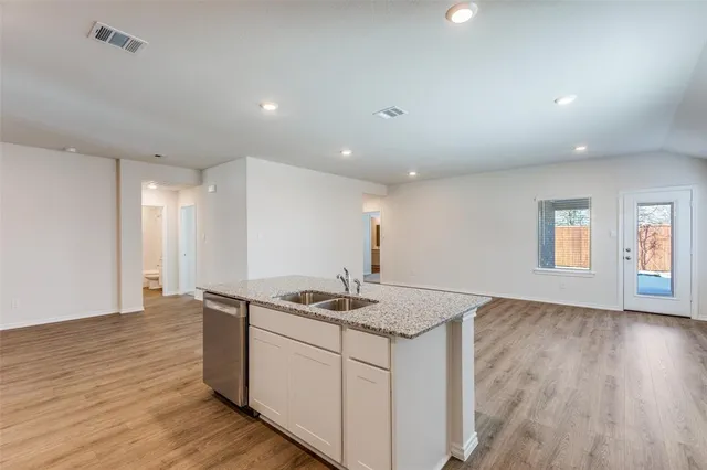 a kitchen that has a sink and a stove in it