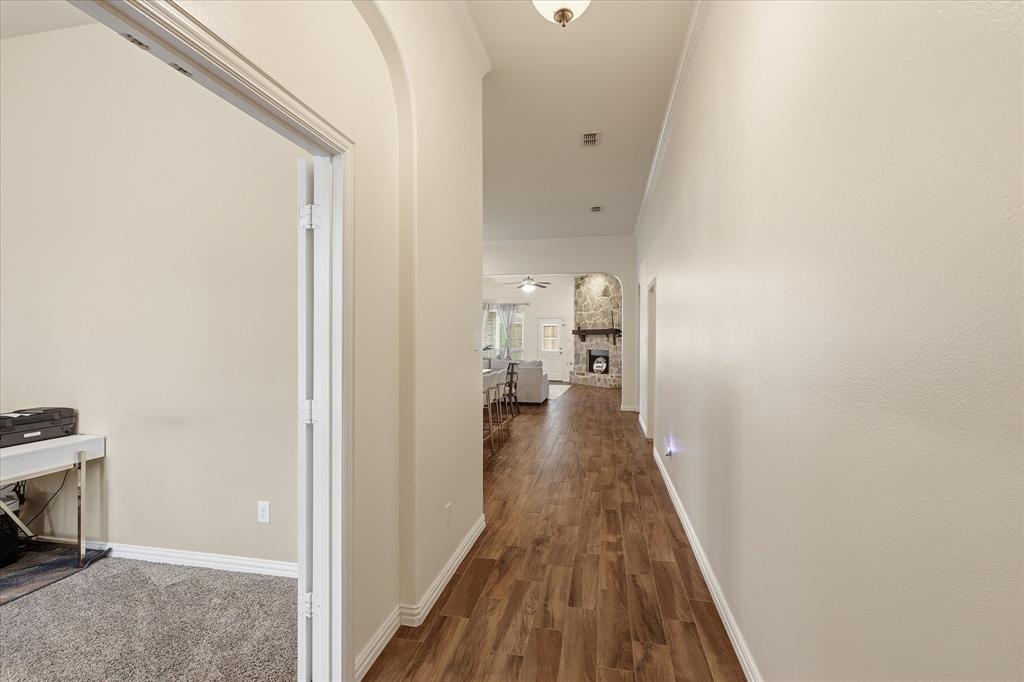 215 Equestrian Road Hickory Creek, TX 75065 - Photo 6 of 36 a view of a hallway with wooden floor and a bathroom