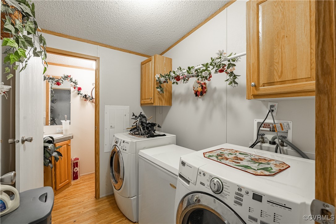 1107 Free State Road Meherrin, VA 23954 - Photo 28 of 45 Laundry room featuring cabinets, light hardwood /
