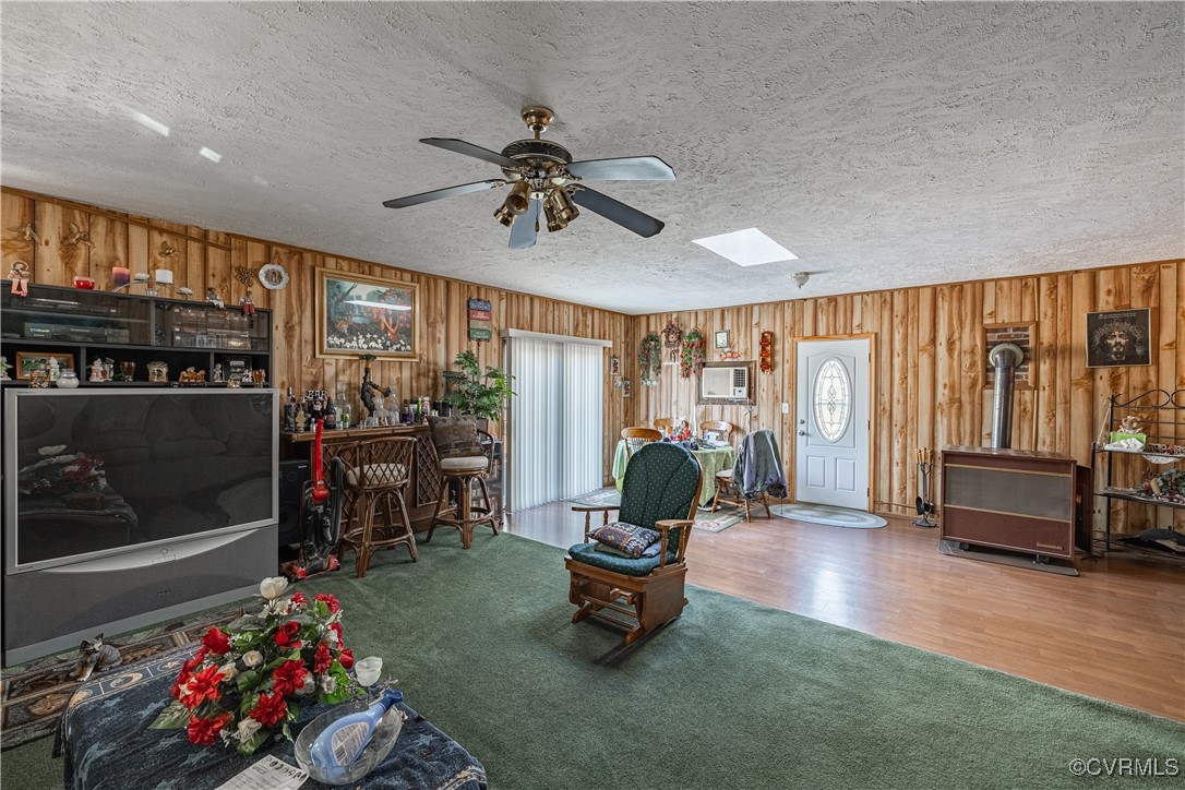 1107 Free State Road Meherrin, VA 23954 - Photo 31 of 45 Living room with wood walls, a skylight, ceiling f