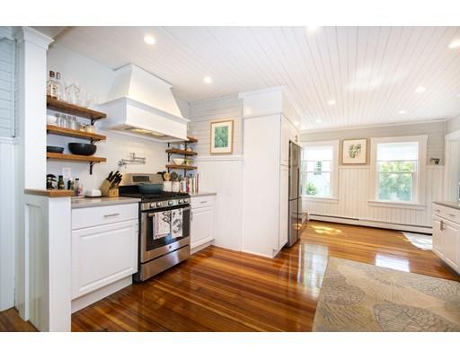 99 Hatherly Road Scituate, MA 02066 - Photo 12 of 31 a kitchen with a refrigerator and white cabinets