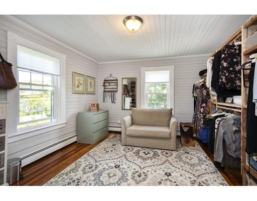 99 Hatherly Road Scituate, MA 02066 - Photo 20 of 31 a living room with furniture a window and a flat screen tv
