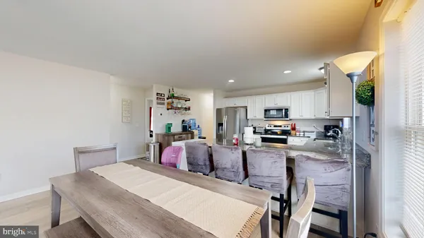 a view of kitchen dining table and chairs