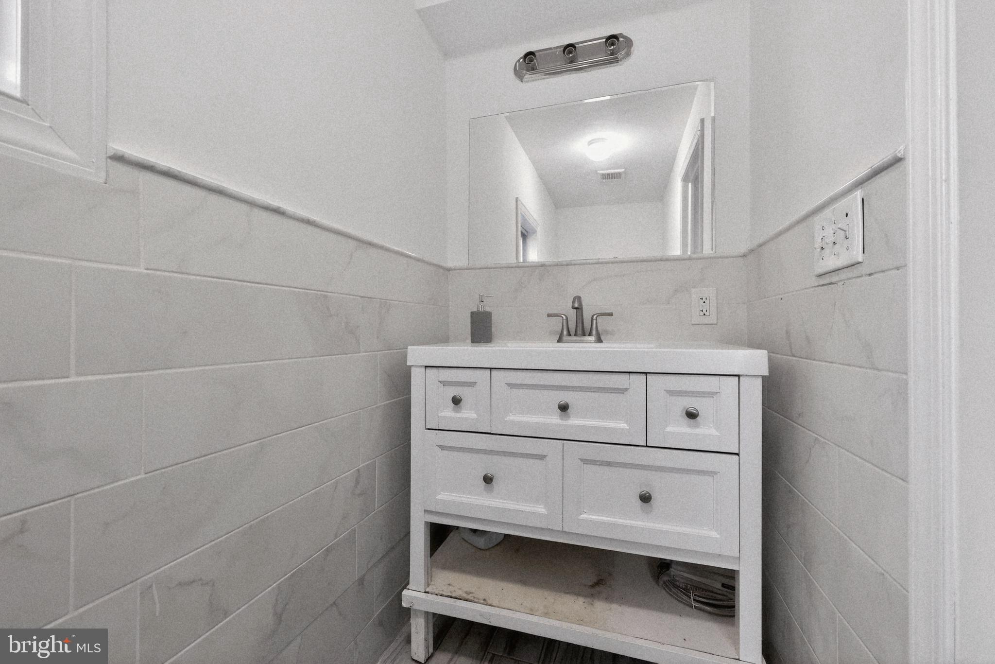 38 East Hancock Street Riverside, NJ 08075 - Photo 12 of 13 a bathroom with a sink vanity and a mirror