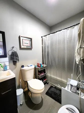 a bathroom with a toilet a sink and a shower