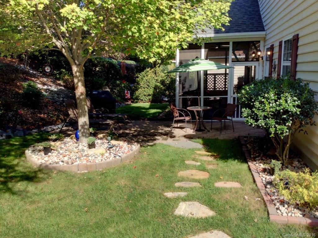 3233 Sapphire Lane Fort Mill, SC 29708 - Photo 17 of 24 a view of a patio with table and chairs potted plants and large tree