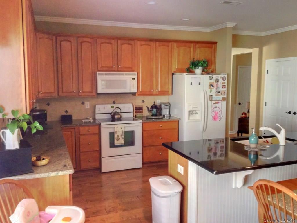3233 Sapphire Lane Fort Mill, SC 29708 - Photo 6 of 24 a kitchen with stainless steel appliances granite countertop a refrigerator a stove a sink dishwasher and white cabinets with wooden floor