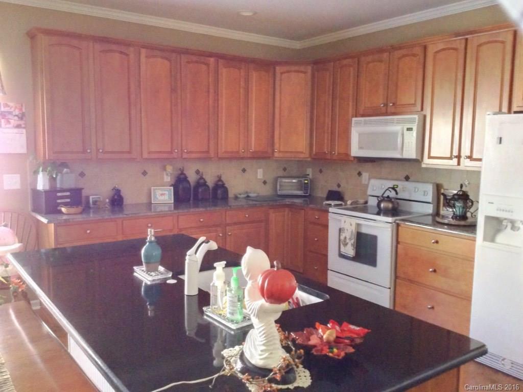 3233 Sapphire Lane Fort Mill, SC 29708 - Photo 7 of 24 a kitchen with a sink dishwasher and a stove with wooden floor