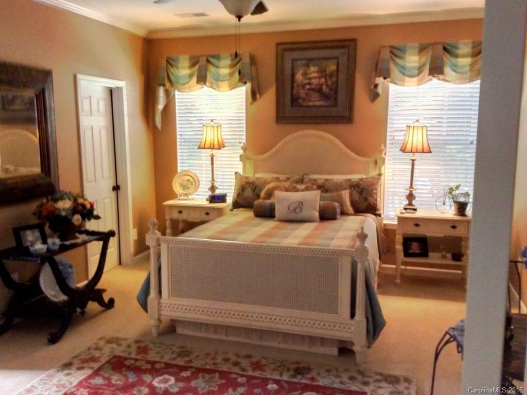 3233 Sapphire Lane Fort Mill, SC 29708 - Photo 9 of 24 a bedroom with a bed and wooden floor