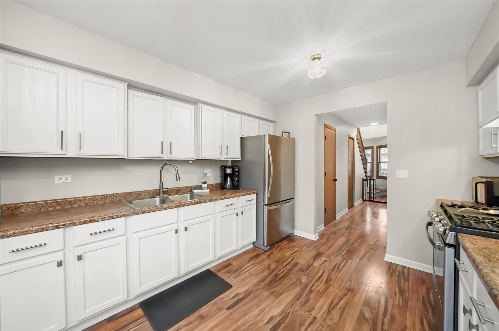 144 Spring Court North Carpentersville, IL 60110 - Photo 14 of 36 a kitchen with refrigerator stove and wooden floor