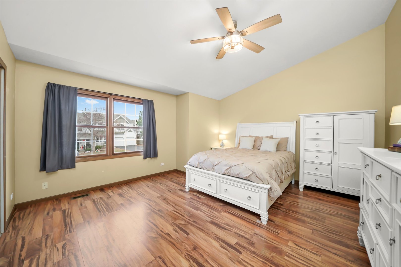 144 Spring Court North Carpentersville, IL 60110 - Photo 16 of 36 a spacious bedroom with a large bed and a chandelier
