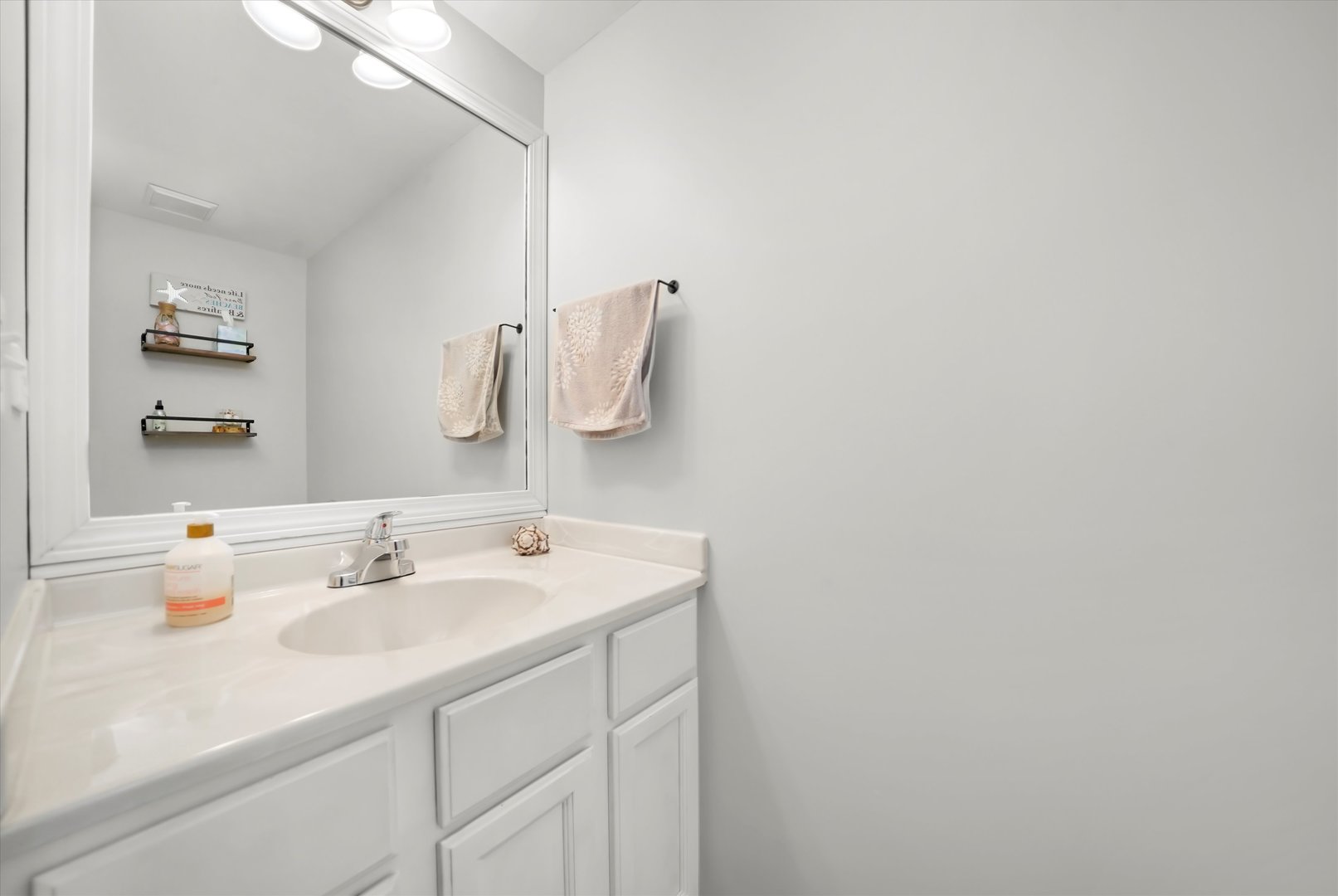 144 Spring Court North Carpentersville, IL 60110 - Photo 25 of 36 a bathroom with a sink and a mirror
