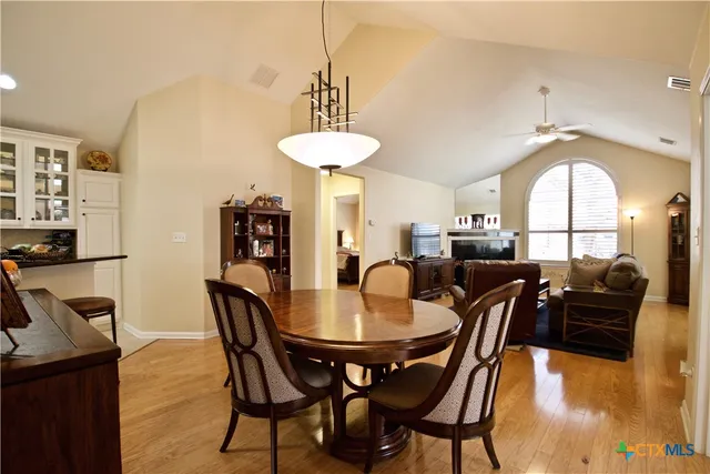 a view of a dining room with furniture and chandelier