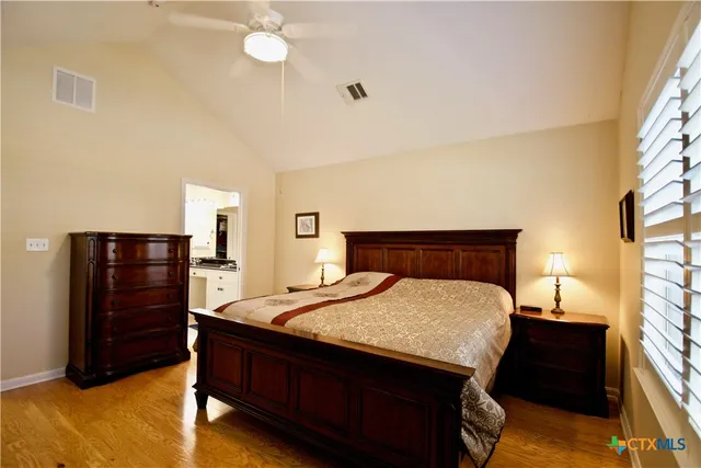 a bedroom with a bed and cabinet