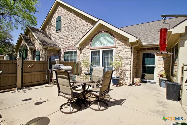 a view of a dinning table and chairs in the patio