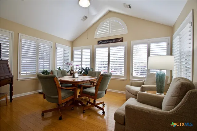 a dining room with furniture and windows