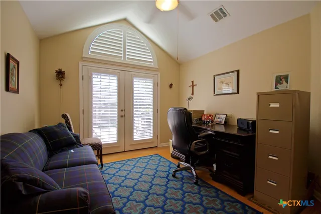 a livingroom with workspace and a window