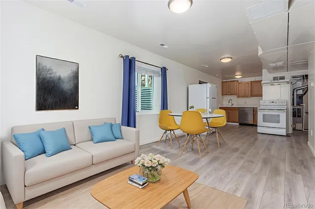 a living room with furniture a fireplace and kitchen view
