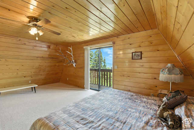 1180 Oak Road Coalville, UT 84017 - Photo 13 of 25 Unfurnished bedroom featuring access to exterior, wooden ceiling, wooden walls, and carpet flooring