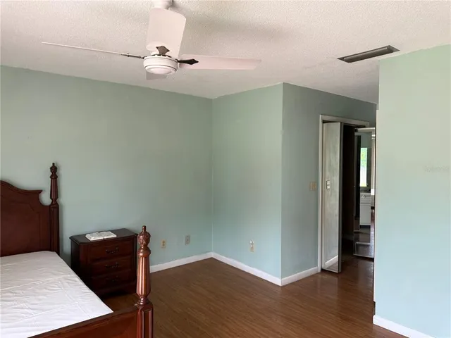 a view of a workspace with furniture and wooden floor