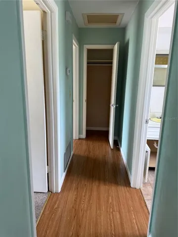 a view of a hallway with wooden floor