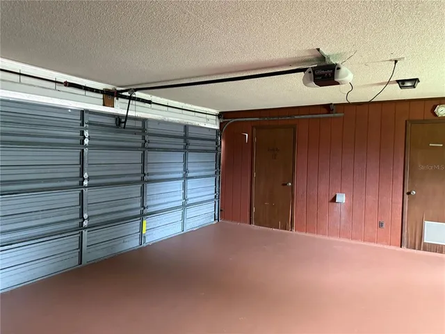 a kitchen with a refrigerator and a stove top oven
