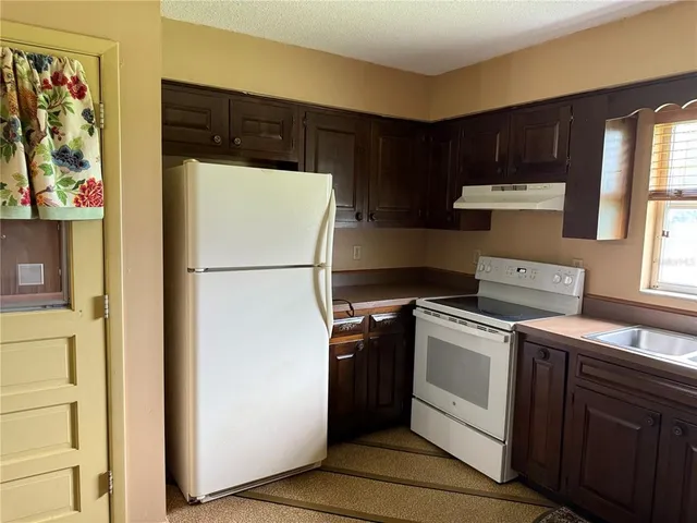 a view of a dining room with furniture and chandelier