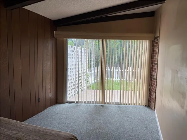 a bed sitting in a bedroom next to a wooden cabinet