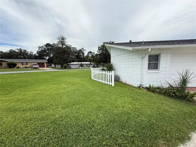 a view of a house with a backyard