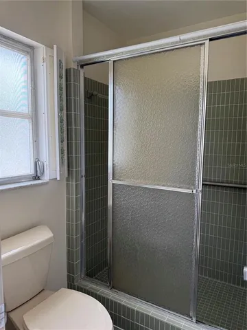a bathroom with a shower and a toilet